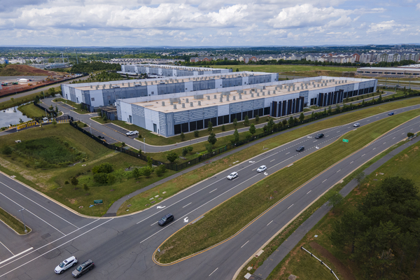 Traffic passes data centers in Ashburn, Va. The centers house the computer servers and hardware required to support modern internet use, including artificial intelligence.