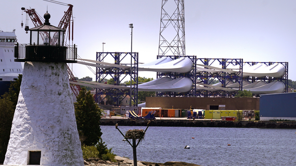 Giant wind turbine blades for the Vineyard Wind project are stacked on large racks in New Bedford, Massachusetts. 