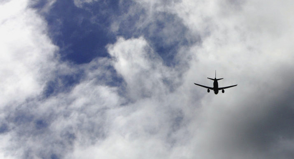 A plane flies into clouds. 