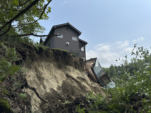 A damaged house sits on a ledge after flooding in Lyndonville, Vermont, last week. 