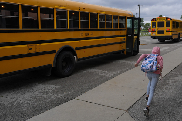 A student races to a school bus.