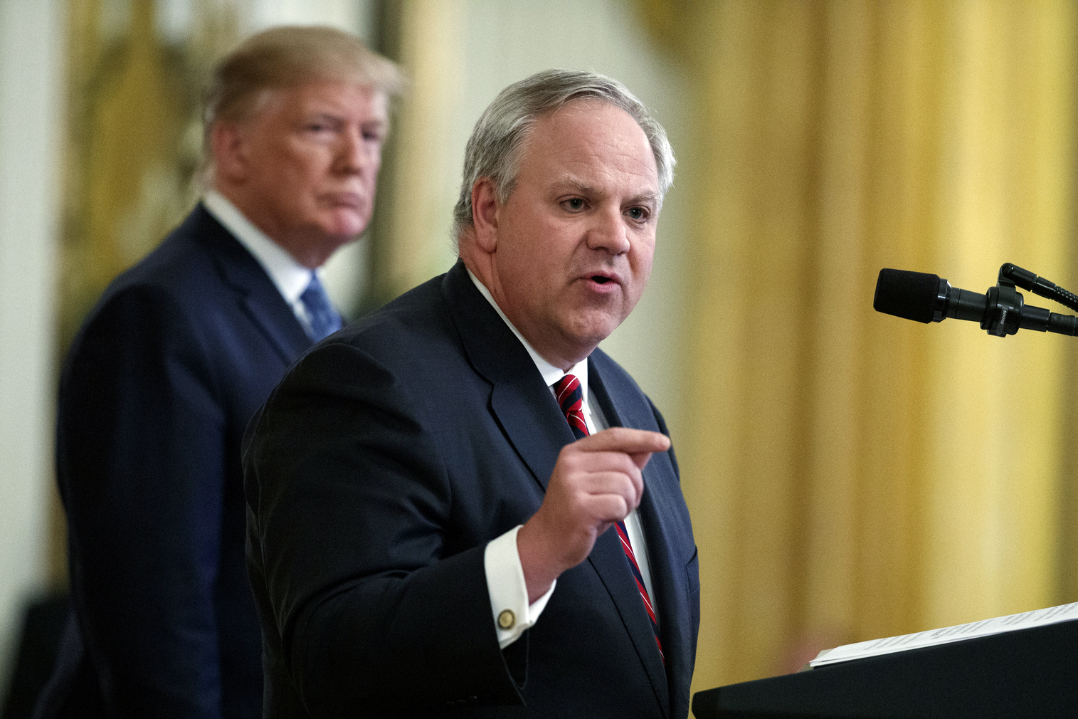 President Donald Trump listens as Secretary of the Interior David Bernhardt speaks 